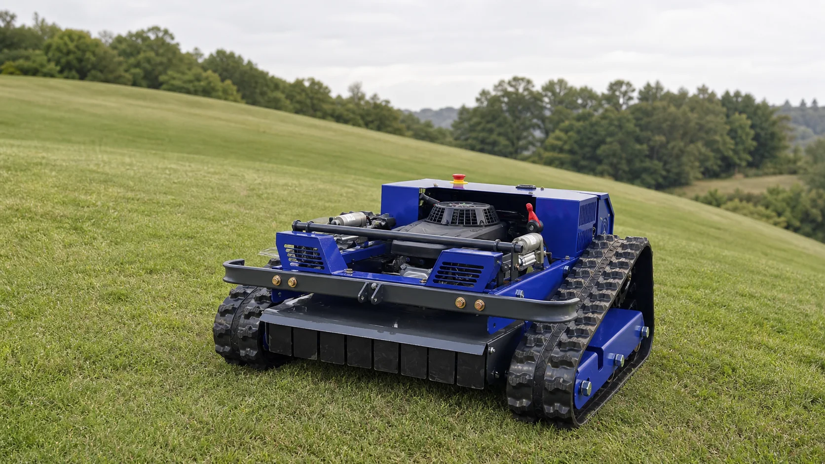 Compact blue tracked remote mower working on open sloped grassland